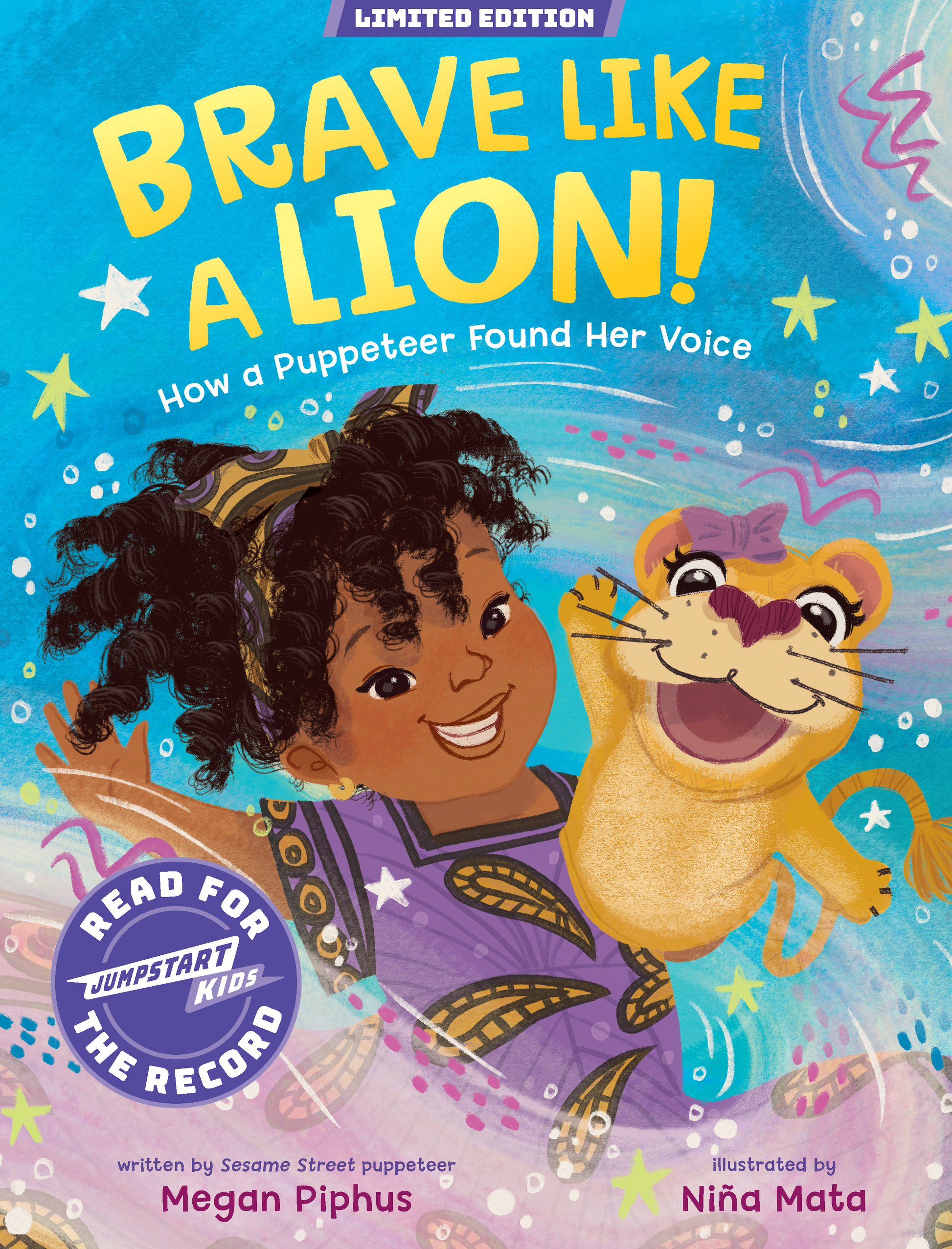 Front cover of the children's book 'Brave Like a Lion! How a Puppeteer Found Her Voice' showing an illustrated girl with curly hair and a lion puppet against a bright blue starry background.  'Limited Edition,' 'Read for Jumpstart Kids the Record,' and creators Megan Phipus and Niña Mata.