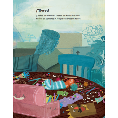 A colorful children's book or illustrated page with Spanish text at the top and a playful scene below showing a pink storage box, blue chair, table, and many small toy-like objects scattered across the surface.